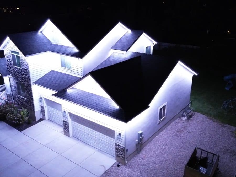Aerial video of a multi-gable estate in Oak Brook, IL with warm white permanent roofline lighting