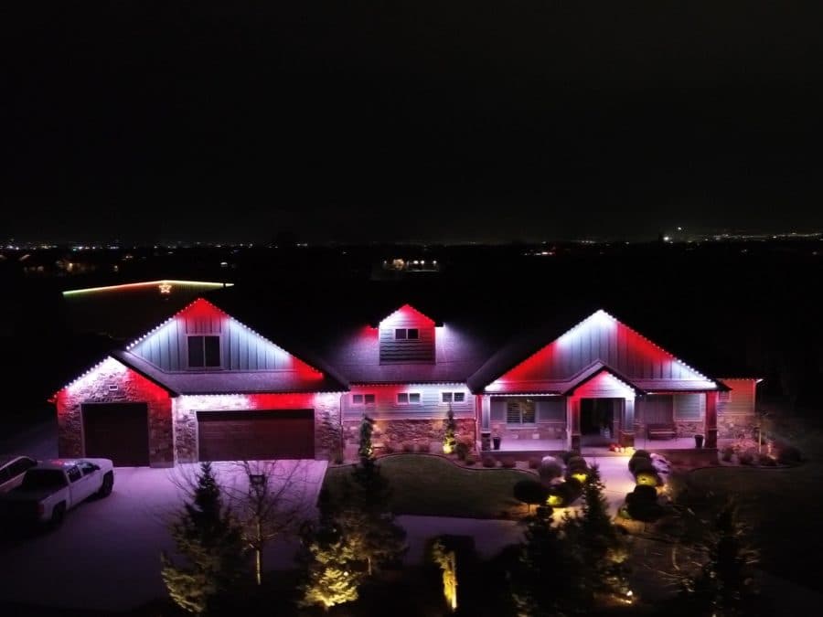Aerial video of a ranch home in Oak Brook, IL with red and white permanent roofline lighting
