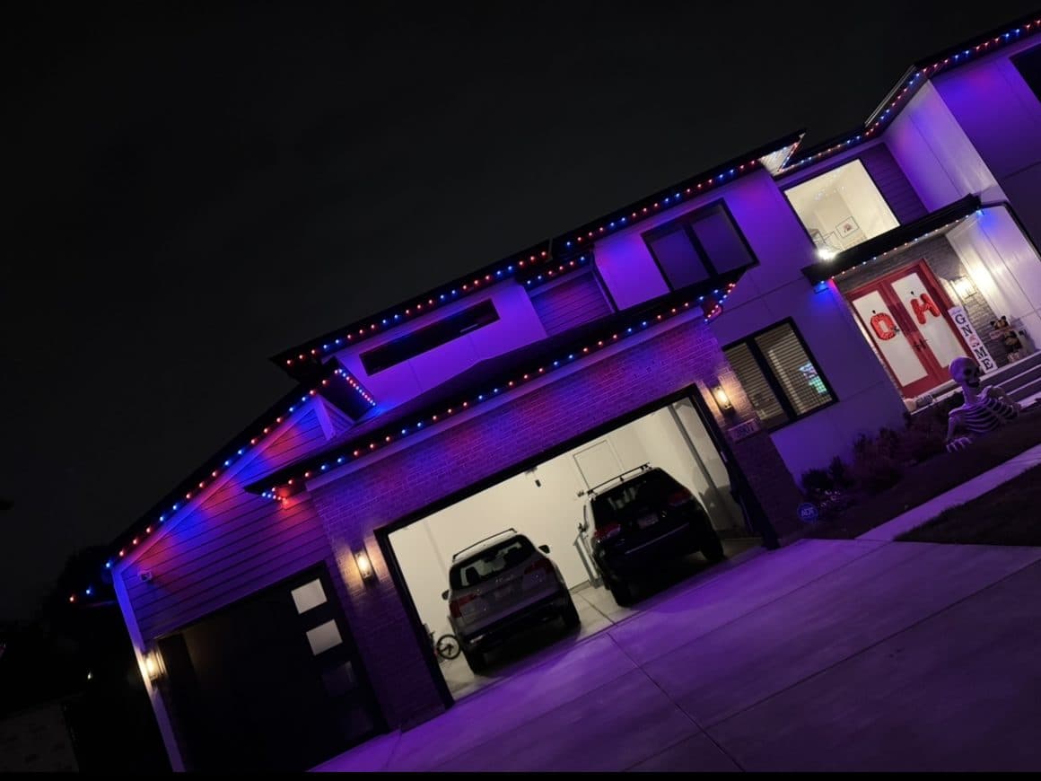 Modern home in Wheaton, IL with permanent lighting set to a purple and blue Halloween scene