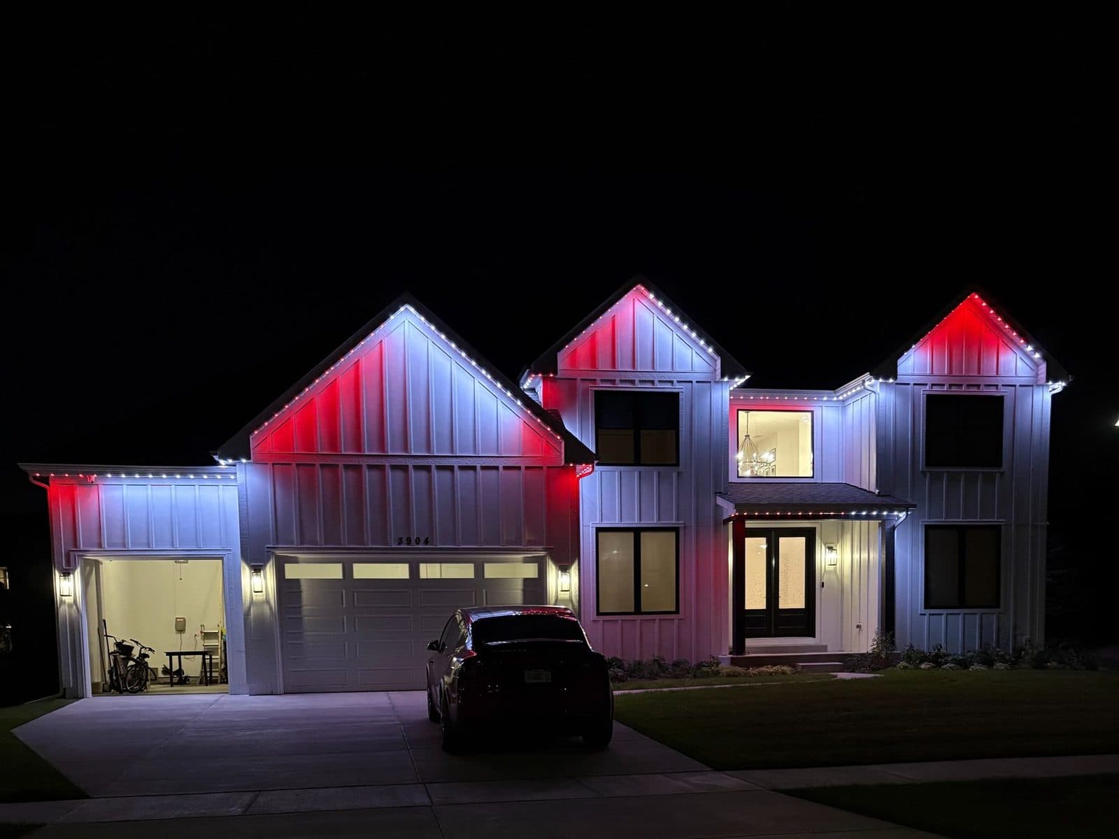 Modern farmhouse in Naperville, IL with color-changing permanent exterior lighting