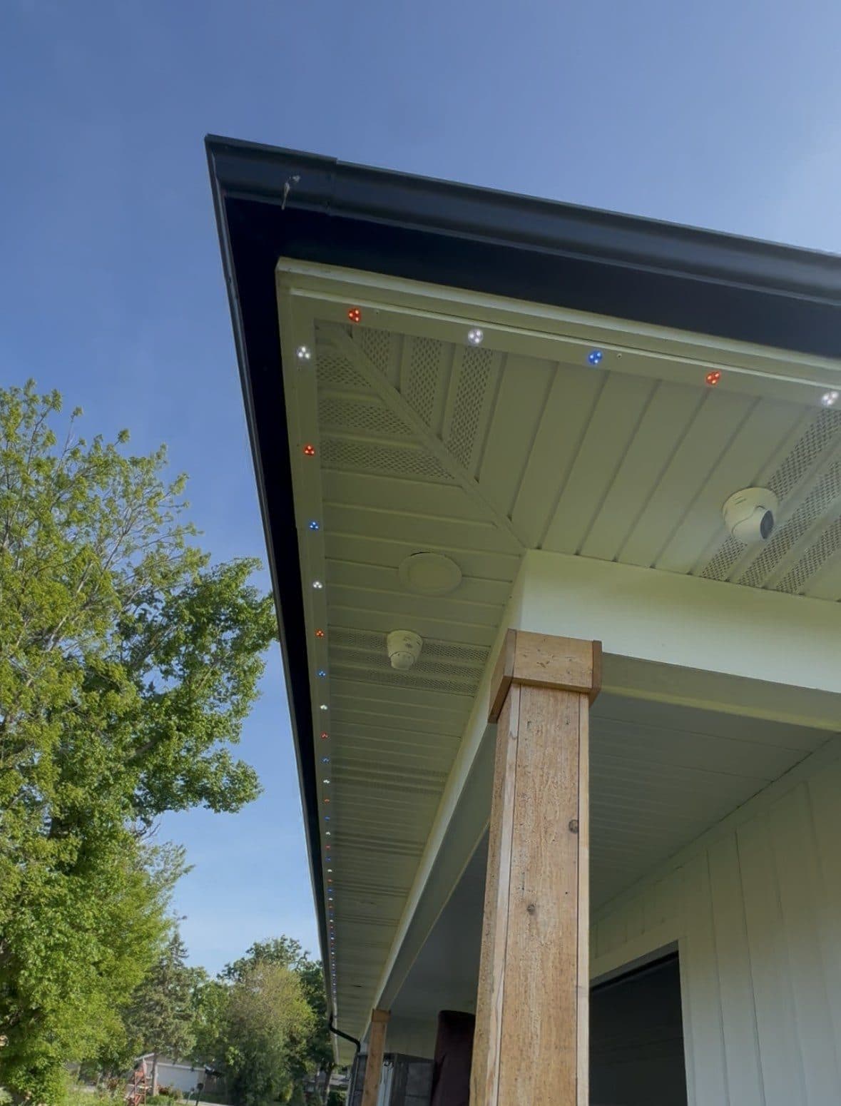TruLight fixtures mounted flush into a home's soffit, photographed in daylight